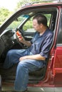 Auto Mechanic Reading A Fault Code Scanner