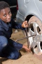 Auto mechanic removes the tire from a car.