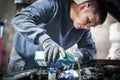 Auto mechanic repairer pours new motor oil into car engine Royalty Free Stock Photo