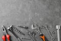 Auto mechanic`s tools on grey stone table. Space for text Royalty Free Stock Photo