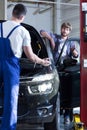Auto mechanic servicing a car Royalty Free Stock Photo