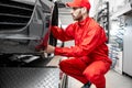 Auto mechanic servicing sports car Royalty Free Stock Photo