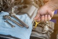 Auto mechanic with tool working check and fixed an old car engine at service station,change and repair before drive Royalty Free Stock Photo