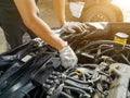 Auto mechanic with tool working check and fixed an old car engine at service station,change and repair before drive Royalty Free Stock Photo