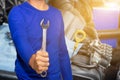 Auto mechanic with tool working check and fixed an old car engine at service station,change and repair before drive Royalty Free Stock Photo