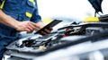 Auto Mechanic Using Digital Tablet for Car Diagnostics Royalty Free Stock Photo