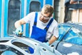 Auto mechanic worker polishing bumper car