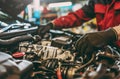 Auto mechanic working on car engine in mechanics garage. Repair service. authentic close-up shot Royalty Free Stock Photo