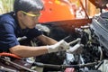 Auto mechanic working on car engine in mechanics garage. Repair service Royalty Free Stock Photo