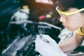 Auto mechanic working on car engine in mechanics garage. Repair service Royalty Free Stock Photo