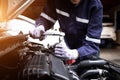 Auto mechanic working on car engine in mechanics garage.Repair service,car service, repair, maintenance concept Royalty Free Stock Photo