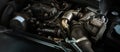 Auto mechanic working on car engine in mechanics garage. Repair service. Close-up shot Royalty Free Stock Photo