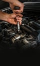 Auto mechanic working on car engine in mechanics garage. Repair service. Close-up shot. Free space for text, copy space Royalty Free Stock Photo