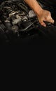 Auto mechanic working on car engine in mechanics garage. Repair service. Close-up shot. Free space for text, copy space Royalty Free Stock Photo