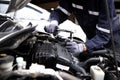 Auto mechanic working on car engine in mechanics garage.Repair service,car service, repair, maintenance concept Royalty Free Stock Photo