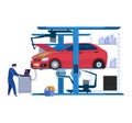 Auto mechanic working on a diagnostic computer next to a lifted red car in a garage. Car repair and maintenance services Royalty Free Stock Photo