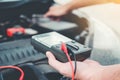 Auto mechanic working in garage Technician Hands of car mechanic working in auto repair Service and Maintenance car battery check Royalty Free Stock Photo