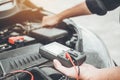 Auto mechanic working in garage Technician Hands of car mechanic working in auto repair Service and Maintenance check car battery Royalty Free Stock Photo