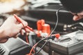 Auto mechanic working in garage Technician Hands of car mechanic working in auto repair Service and Maintenance check car battery Royalty Free Stock Photo