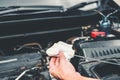 Auto mechanic working in garage Technician Hands of Mechanic Oil Check mechanic working in auto repair Service and Maintenance car Royalty Free Stock Photo