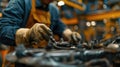 Auto mechanic working in auto repair service. Closeup of male hands in gloves repairing car engine. Royalty Free Stock Photo