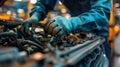 Auto mechanic working in auto repair service. Closeup of male hands in gloves repairing car engine. Royalty Free Stock Photo