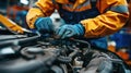 Auto mechanic working in auto repair service. Closeup of male hands in gloves repairing car engine. Royalty Free Stock Photo