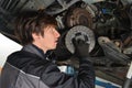 Auto mechanic working under the car and changing clutch Royalty Free Stock Photo
