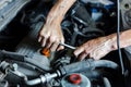An auto mechanic works with a car engine in the mechanics' garage. Car repair close-up. Royalty Free Stock Photo