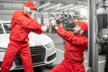 Auto mechanics fighting with wrenches in the car service