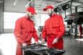 Auto mechanics with wrenches at the car service Royalty Free Stock Photo