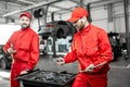 Auto mechanics with wrenches at the car service Royalty Free Stock Photo