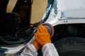 Auto painter polishing plastered car body part