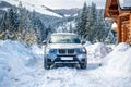 Auto parked in the classic winter mountain scenery Royalty Free Stock Photo