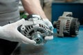 Auto parts. Close-up of a new generator in the hands of a mechanic. Royalty Free Stock Photo