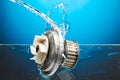 Auto parts, engine cooling pump in water splash on blue background