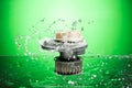 Auto parts, engine cooling pump in water splash on green background