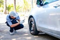 Auto repair technician Holding a smartphone to take pictures of the wheels Royalty Free Stock Photo