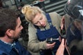 auto repairman and female apprentice grinding autobody bonnet Royalty Free Stock Photo