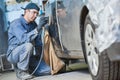 Auto repairman grinding autobody bonnet Royalty Free Stock Photo