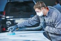 Auto repairman grinding autobody bonnet Royalty Free Stock Photo