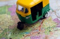 Auto rickshaw toy driving on Rajasthan map with Jaipur city and others. Indian roads maps of India