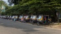 Auto rickshaws in a line on an Indian road