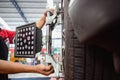 Auto service mechanic installing wheel alignment sensor on tire during vehicle suspension alignment adjustment. and set the car Royalty Free Stock Photo