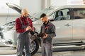 Auto service, repair, maintenance and people concept - mechanic men with wrench repairing car engine at workshop Royalty Free Stock Photo