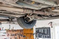 Auto service shop has lift for easy working on underside of car Royalty Free Stock Photo