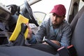 Auto service staff cleaning car interior Royalty Free Stock Photo