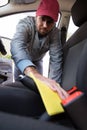 Auto service staff cleaning car interior