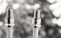 Auto service. Two new spark plugs as spare part of car. Royalty Free Stock Photo