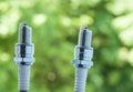 Auto service. Two new spark plugs as spare part of car. Royalty Free Stock Photo